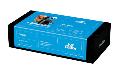 The Daily coffee box packaging in bright blue and black with notes of chocolate caramel and molasses from Joe Coffee