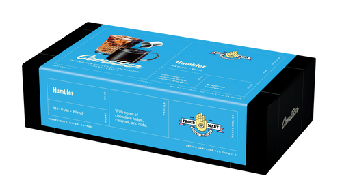 Blue box packaging of Humbler coffee blend with notes of chocolate fudge, caramel, and date, medium roast coffee capsules.