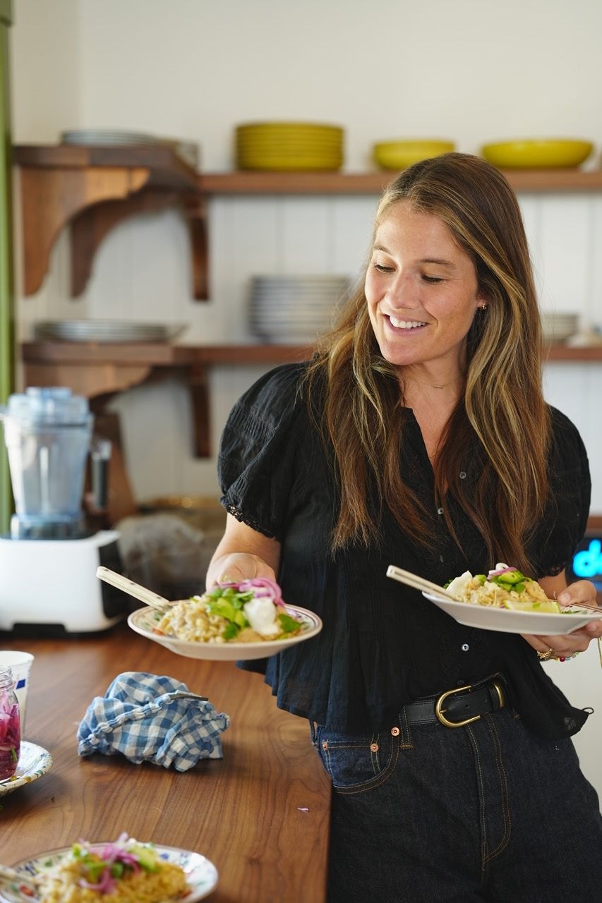 Caro Chambers serving two plates in her kitchen