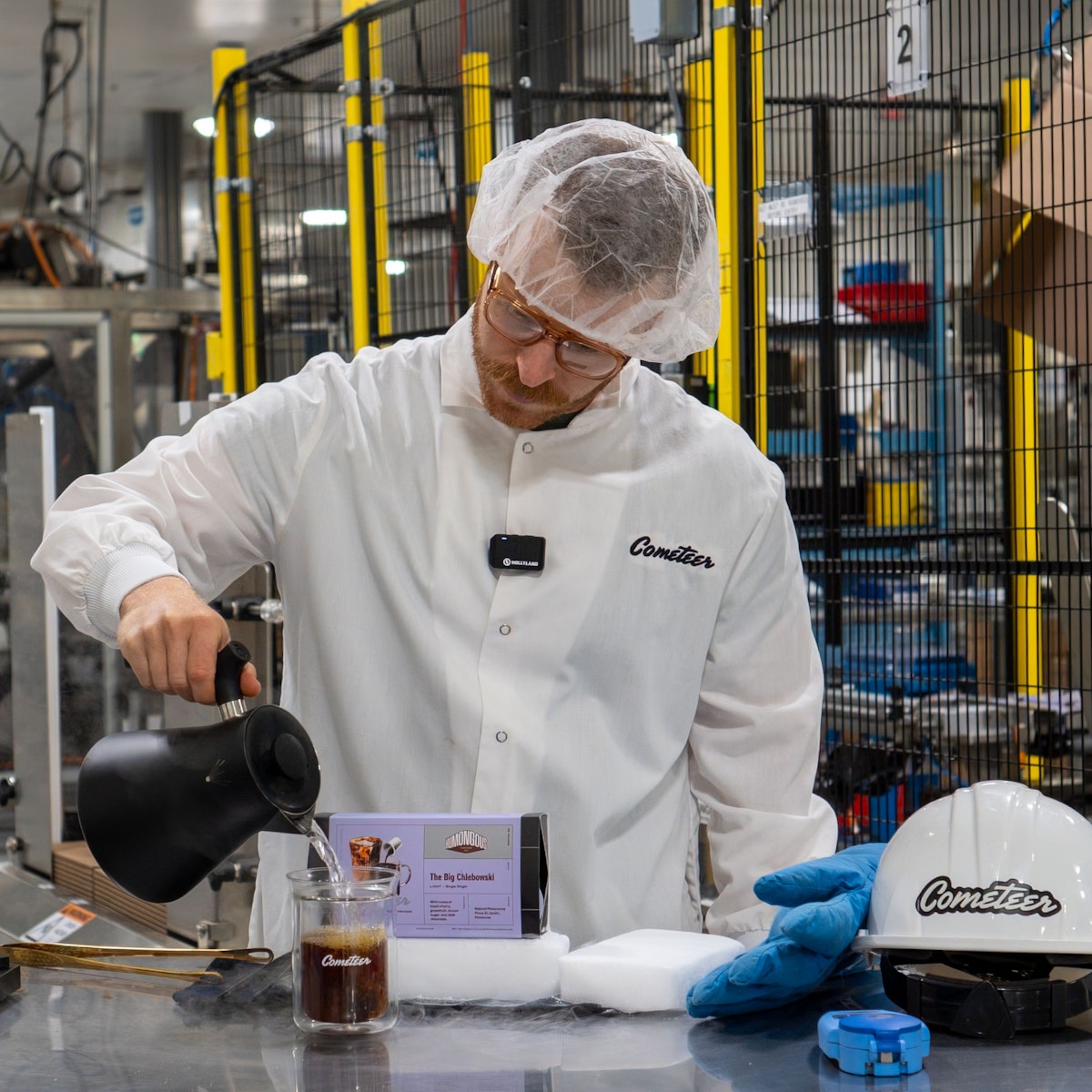 Ethan Chlebowski adding hot water to Cometeer coffee at the factory.