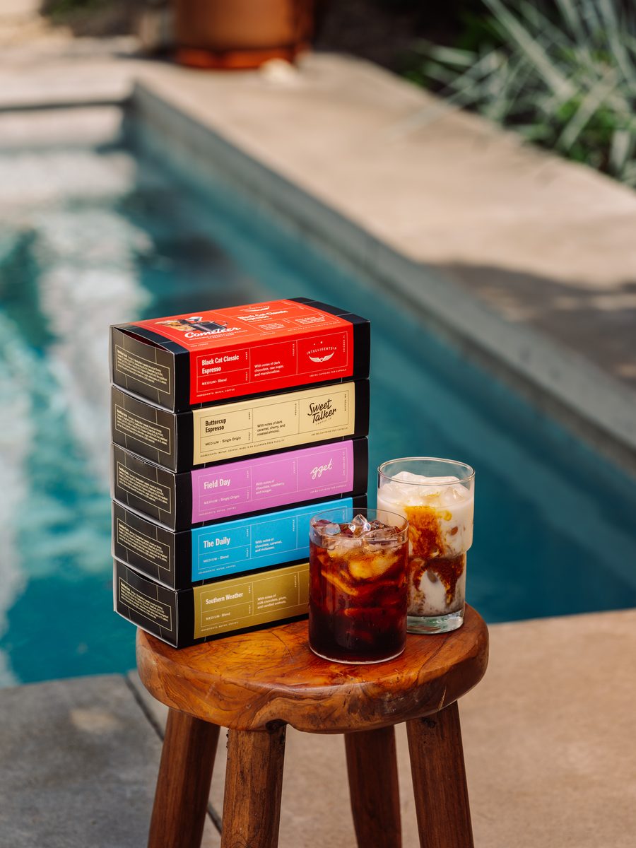 Five Cometeer coffee sleeves beside iced coffee