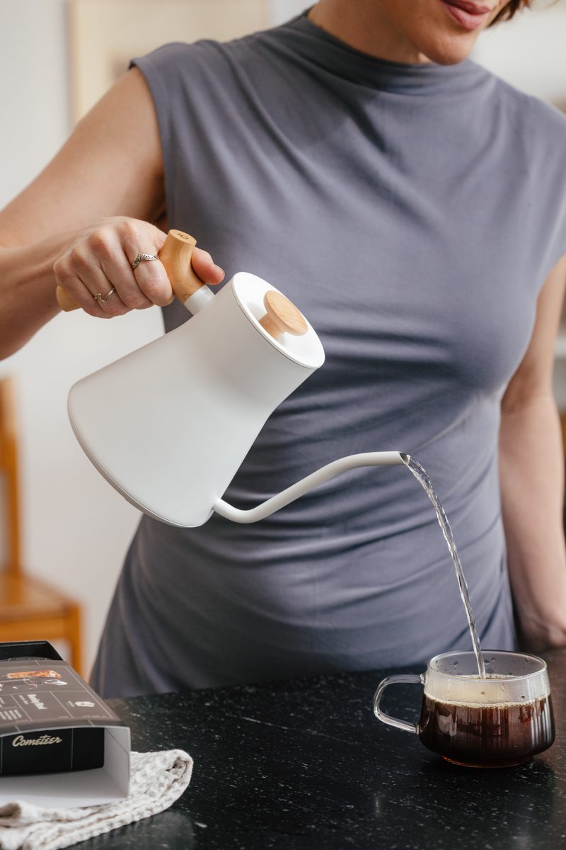 Pouring hot water into Cometeer coffee