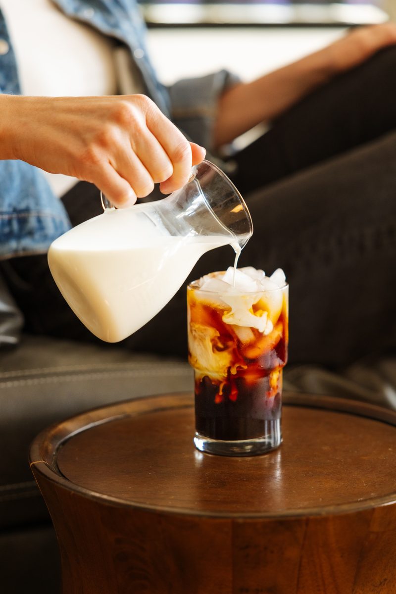 Adding milk to iced Cometeer coffee