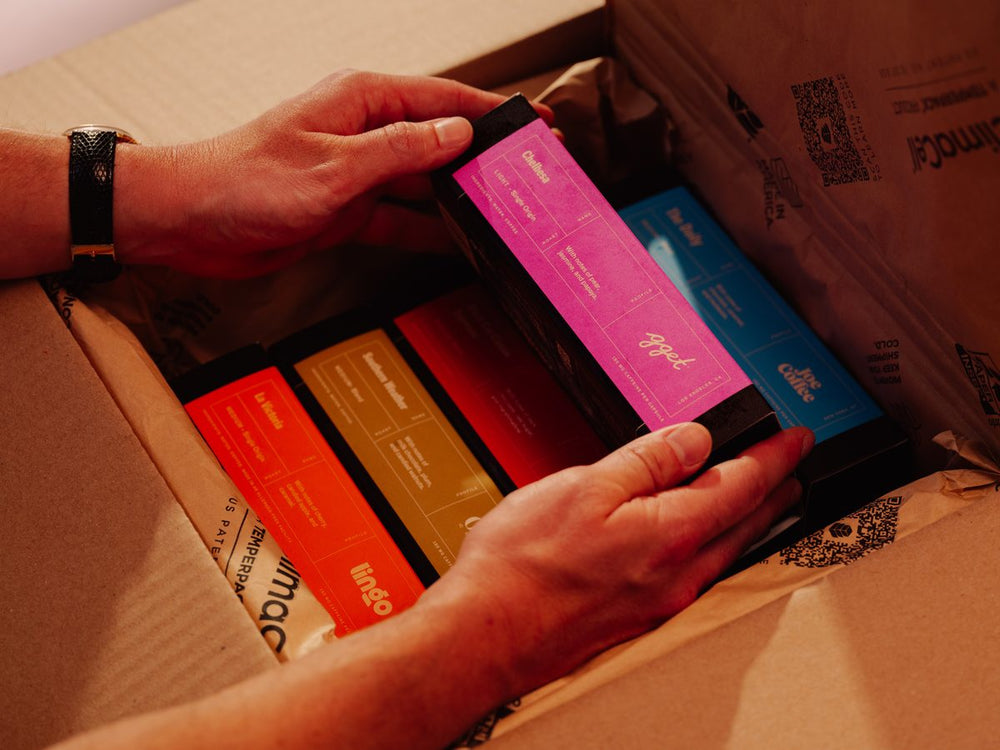 Unpacking colorful Cometeer coffee sleeves