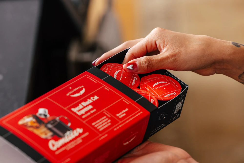 Opening an Intelligentsia Cometeer sleeve to reveal coffee capsules.